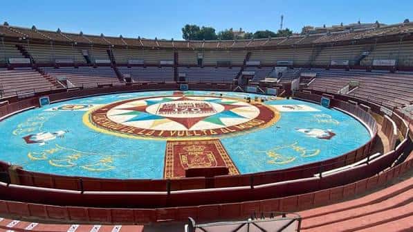 Vista panorámica del interior de la plaza de toros con el ruedo decorado