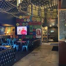 Interior del bar con decoración temática y pantallas de cine