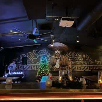 Interior del bar con mural artístico y decoración navideña