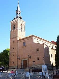 Vista exterior de la Iglesia de San Salvador con terraza y mobiliario al aire libre