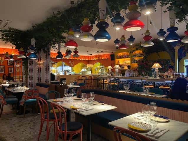 Interior del restaurante con mesas y lámparas coloridas