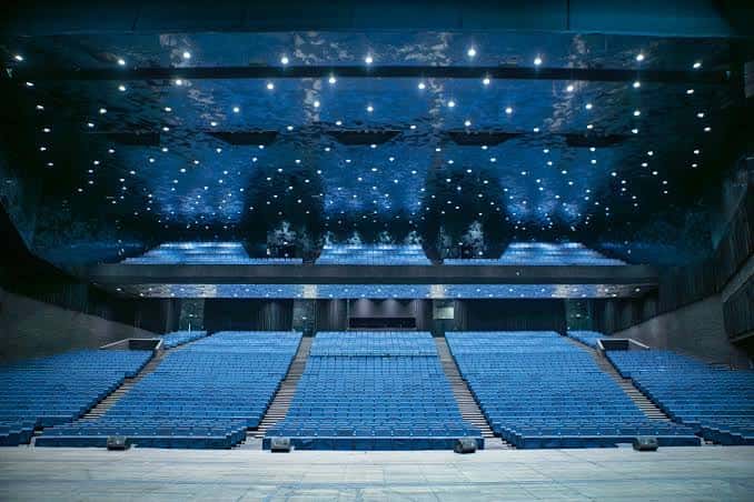 Interior del auditorio con diseño moderno y techo iluminado como cielo estrellado