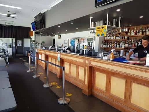Barra de servicio del club con estantería de bebidas y zona de atención al cliente