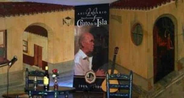 Escenario de la peña con decoración tradicional y guitarra