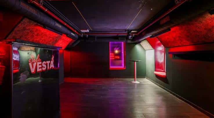 Espacio interior vacío de la sala con luces ambientales y branding visible