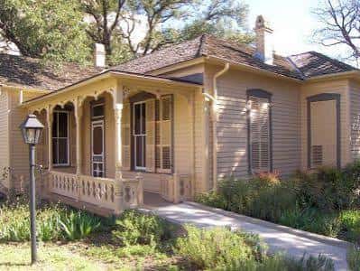 Vista exterior del Museo O. Henry en Austin con porche y jardines