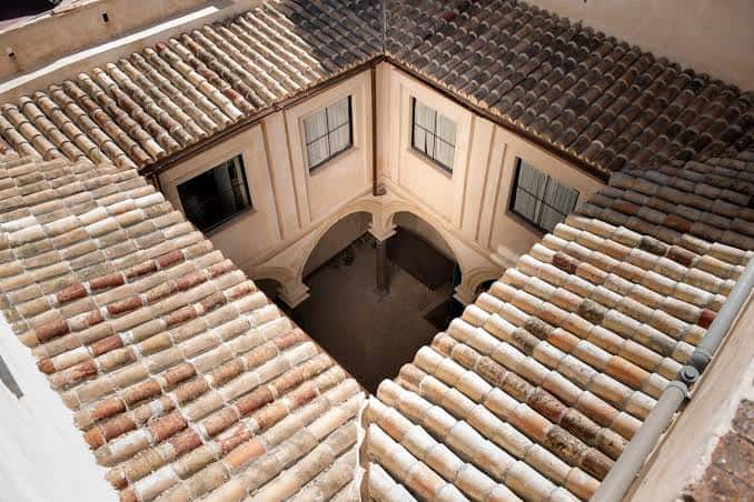 Patio interior con arcos y tejado de tejas árabes
