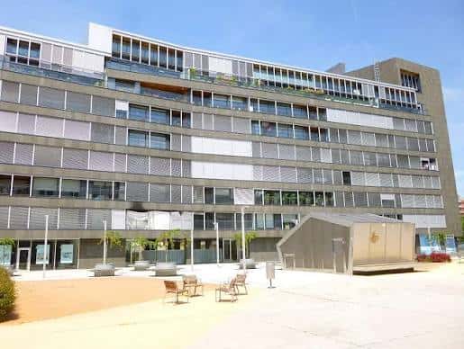 Espacio abierto frente a la Plaza del Renacimiento con áreas de descanso y estructura contemporánea