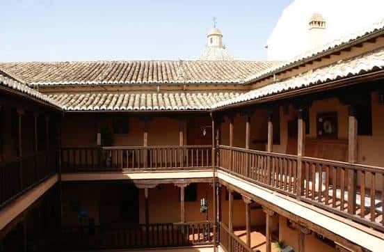 Vista del patio interior de la Corrala de Santiago con balcones de madera y tejado a dos aguas
