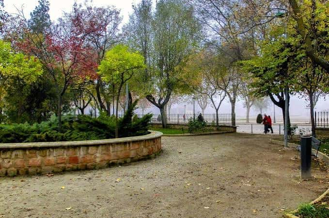 Vista general del parque con árboles de colores otoñales y camino central