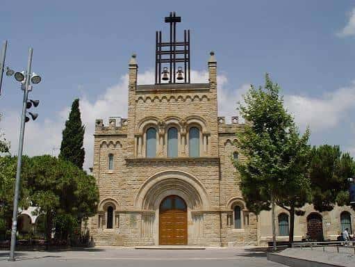 Fachada frontal de la iglesia con campanario y arco de entrada
