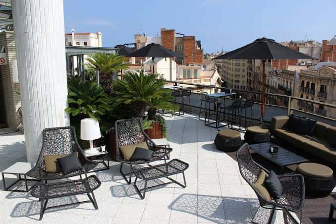 Vista panorámica de la terraza con mobiliario moderno y vistas a la ciudad