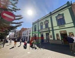 Plaza de San Lázaro con edificios históricos y personas caminando bajo el sol