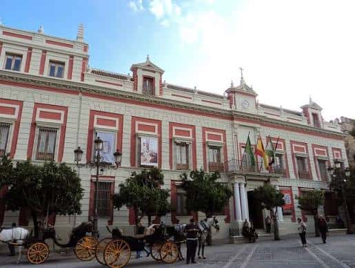 Fachada principal de la Casa de la Provincia con carruaje y banderas