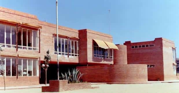 Vista exterior del edificio de la Escola Sant Jordi con fachada de ladrillo rojo y arquitectura moderna