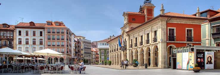 Fachada del Ayuntamiento de Avilés en la Plaza de España con banderas y arquitectura clásica