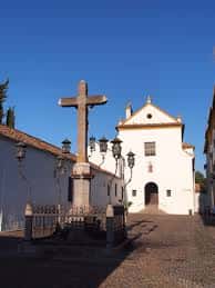 Vista general de la Plaza de Capuchinos con cruz central y fachada blanca