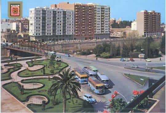 Postcard vintage showing Plaza de la Cruz Roja with buses and palm trees