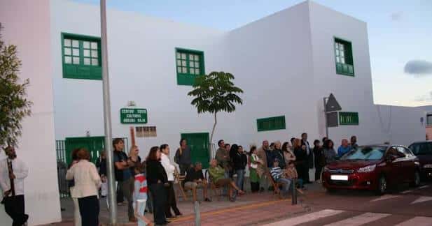 Exterior del centro sociocultural con público reunido en la entrada