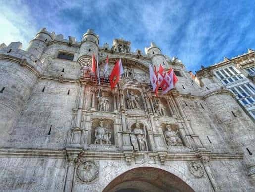 Puerta de Santa María, entrada monumental al casco histórico con esculturas y banderas
