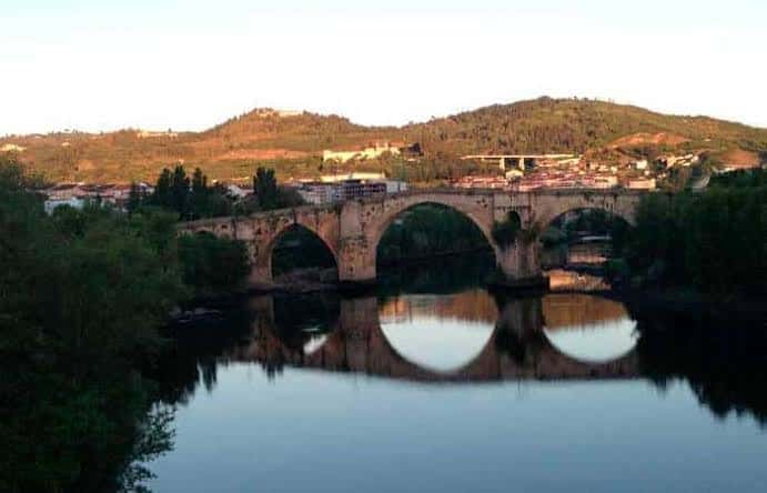 Puente histórico sobre el Río Miño durante la puesta de sol
