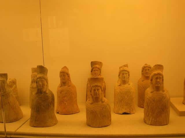 Colección de estatuillas funerarias púnicas expuestas en vitrina
