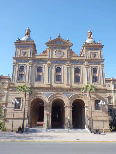 Fachada principal de la Capitanía General de Sevilla con arcos y detalles arquitectónicos