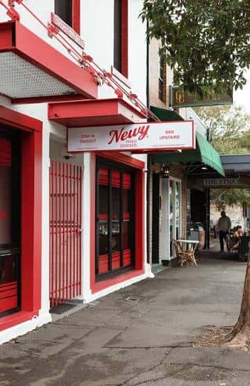 Fachada exterior de Newy Fried Chicken en Darby Street con detalles rojos y blancos