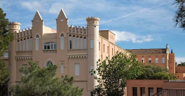 Fachada principal del Col·legi Sagrat Cor de Sarrià con arquitectura gótica y torres