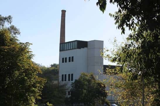 Fachada del edificio entre árboles bajo cielo despejado