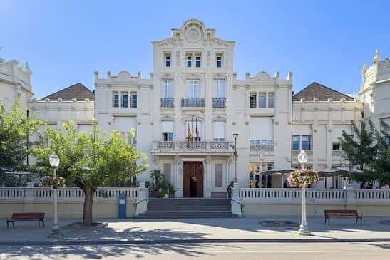 Vista exterior del edificio sede de la asociación con arquitectura clásica y jardines