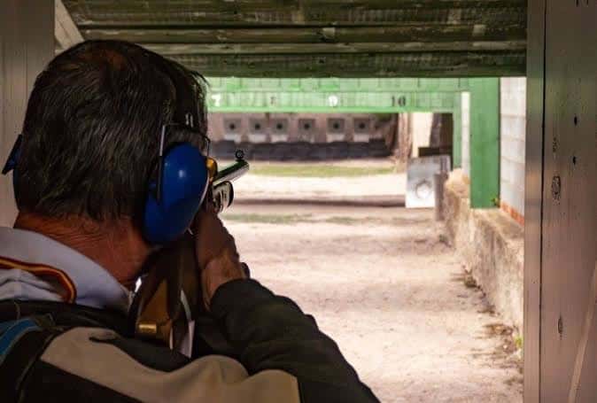 Tirador apuntando con rifle desde la posición de pie