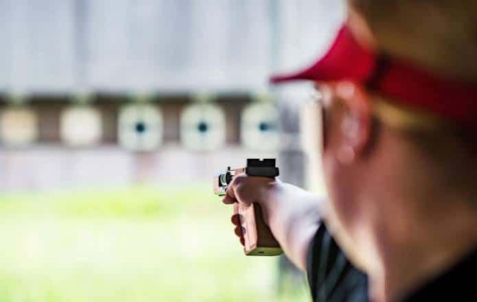 Primer plano de un tirador con pistola olímpica