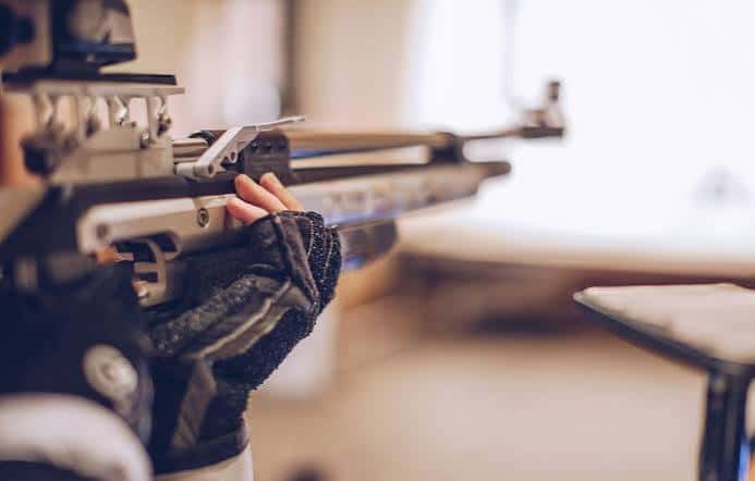 Detalle de las manos y el rifle de competición