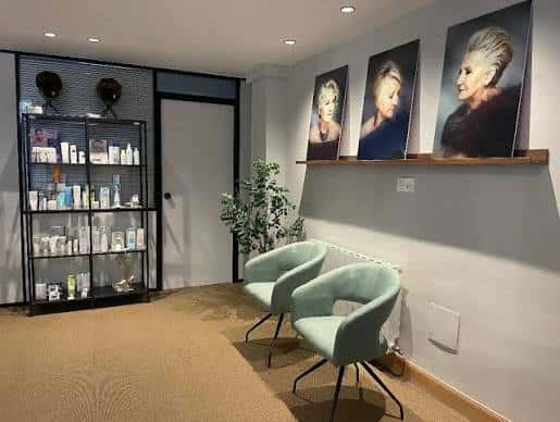 Detalle del área de espera con sillas modernas y estanterías de productos