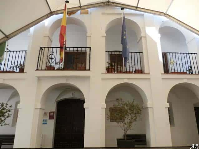 Interior de la capilla con arcos blancos y balcones decorados con banderas