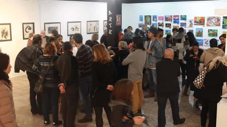 Vista interior de la galería ImaginArte durante una exposición con visitantes observando obras