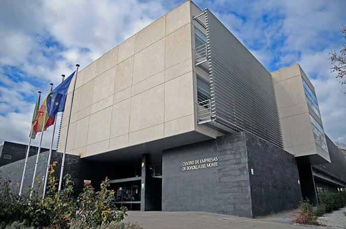 Vista exterior del Centro de Empresas Municipal con fachada moderna y banderas