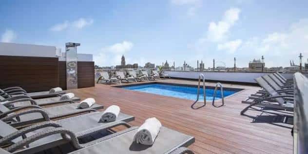 Piscina en la azotea del hotel con vistas a la ciudad de Málaga