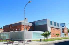Vista exterior del Centro Cultural LÉCRAC con fachada de ladrillo y estructura moderna