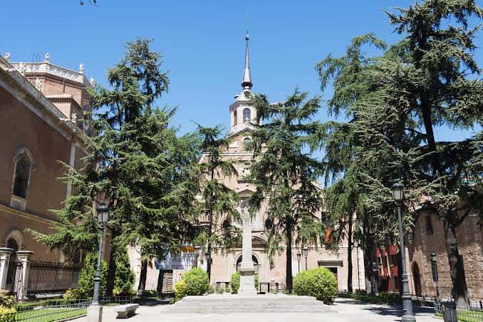 Fachada exterior del Monasterio Cisterciense rodeado de árboles en un día soleado