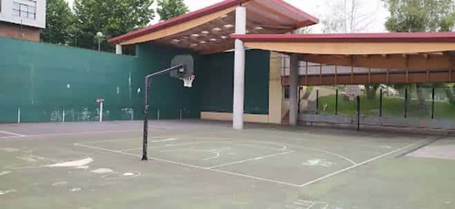 Pabellón deportivo con cancha de baloncesto y frontón adyacente