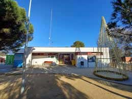 Entrada principal del Casal Les Planes con zona de juegos infantiles al frente
