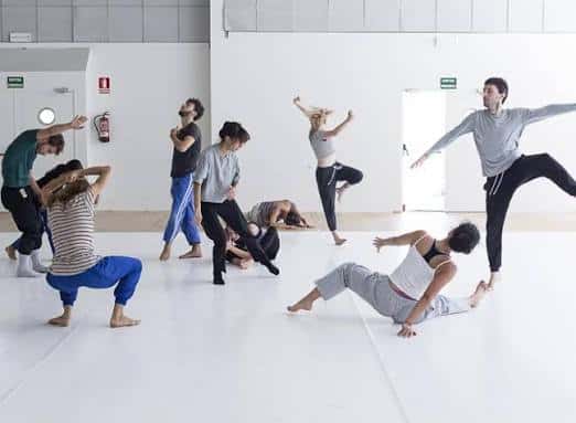 Grupo de bailarines en sesión de ensayo dentro del centro