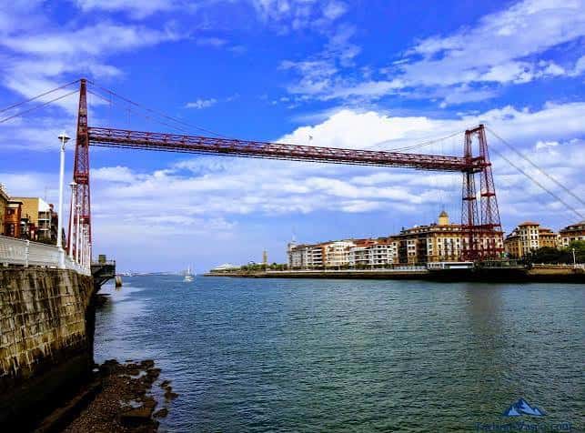 Vista panorámica del Puente Colgante de Bizkaia sobre el río Nervión con cielo azul y nubes