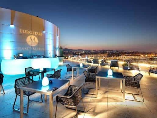 Terraza nocturna del Eurostars Grand Marina con barra iluminada y mesas para eventos