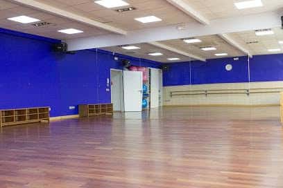 Sala de entrenamiento con suelo de madera y paredes azules