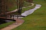Puente de madera sobre el río Rato y caminos verdes