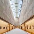 Galería interior del museo con techo acristalado y luz natural