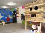 Espacio creativo de MUTA con murales coloridos y estructura de madera
